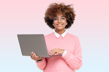 Obraz na płótnie Canvas Studio portrait of smiling african american teen girl looking at camera with laptop in hands