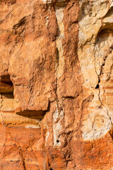 Sedimentary rocks with a high content of iron oxide. Red soil, loam. The texture of the soil.