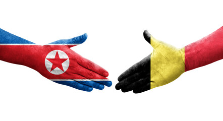Handshake between Belgium and North Korea flags painted on hands, isolated transparent image.