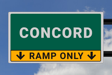 Concord logo. Concord lettering on a road sign. Signpost at entrance to Concord, USA. Green pointer in American style. Road sign in the United States of America. Sky in background