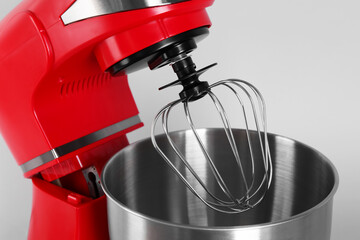 Modern red stand mixer on light gray background, closeup