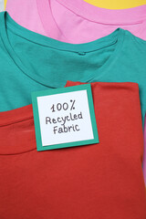 Different clothes with recycling label, closeup view