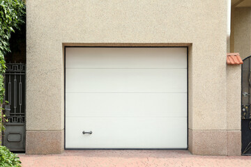 Building with white sectional garage door near entrance