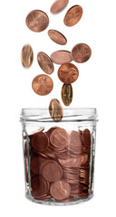 Coins falling into glass jar on white background