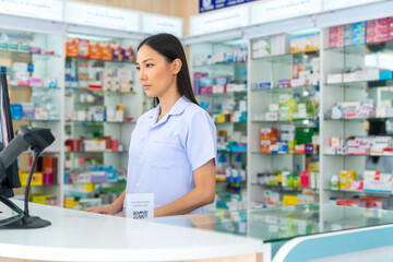 Portrait of Attractive Asian woman professional pharmacist ready for medication advice about...