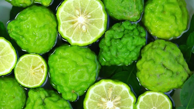 Top view Rotate of Transparent Slice of Bergamot fruit on white background, Close up fresh Bergamot sliced on white background and slowly rotating.