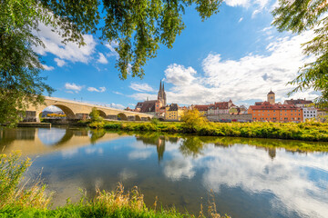 The picturesque skyline including the stone bridge over the Danube River, Saint Peter's Church and...