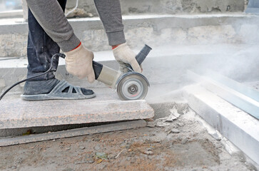 A worker cuts a granite slab