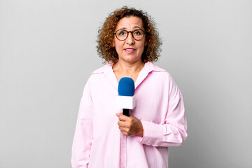 pretty middle age journalist woman with a micro. presenting concept