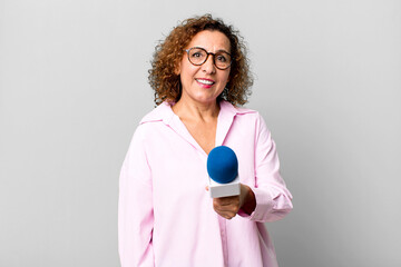 pretty middle age journalist woman with a micro. presenting concept