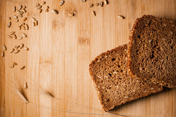 Sliced bread on a wooden table  with sunflower seeds