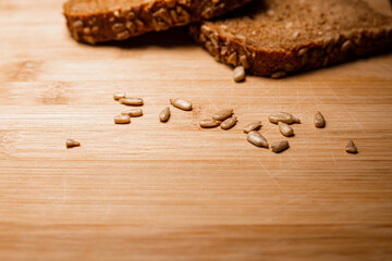 Sliced bread on a wooden table  with sunflower seeds