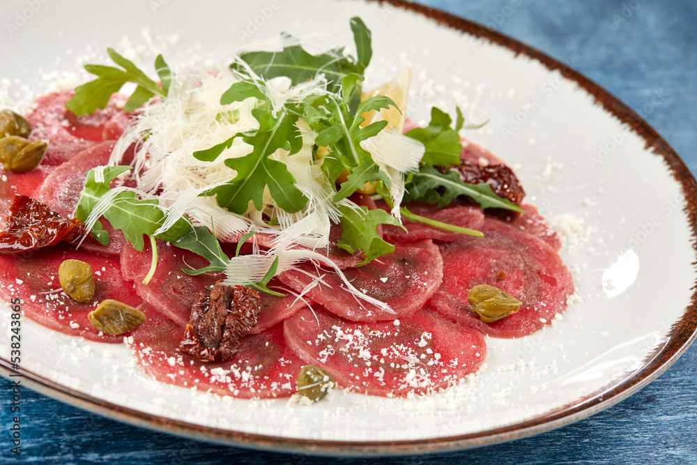 Wall mural beef carpaccio with lemon and parmesan