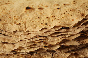 Thin Turkish style flatbread stacked on dozens