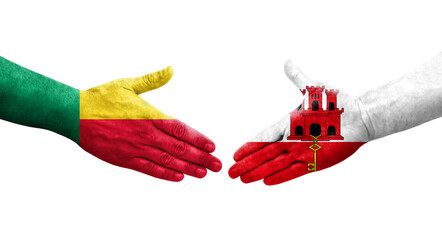 Handshake between Benin and Gibraltar flags painted on hands, isolated transparent image.