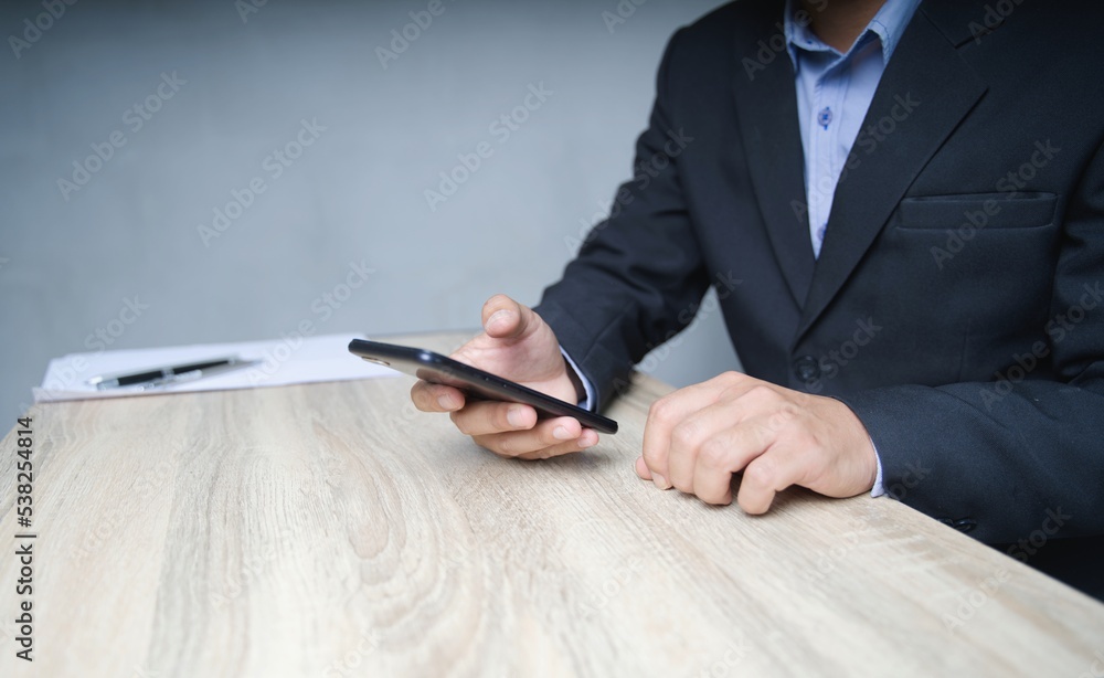 Poster a businessman in a suit uses a smartphone to communicate with clients. view marketing and social net