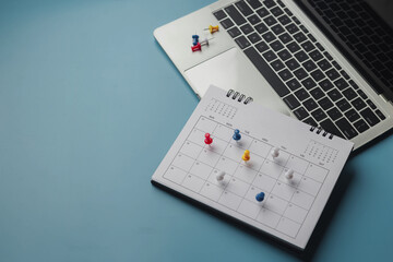 Embroidered red pins on a calendar event Planner calendar,clock to set timetable organize schedule,planning for business meeting or travel planning concept.