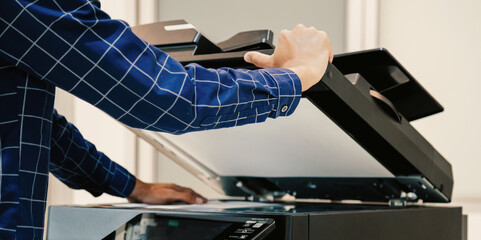 Copier printer, Close up hand office man press copy button on panel to using the copier or photocopier machine for scanning document printing a sheet paper.