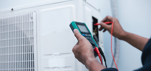 Air conditioner technicians use a multimeter to check electricity and Part of the preparation to install a new air conditioner.