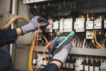 Electricity and electrical maintenance service, Engineer hand holding AC multimeter checking...