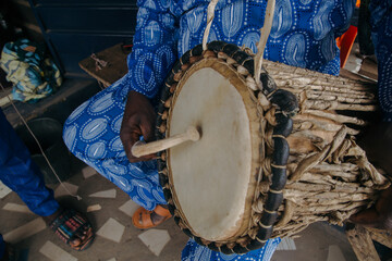 Man playing the talking drum
