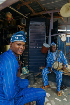 Young adult and his father surrounded by drums