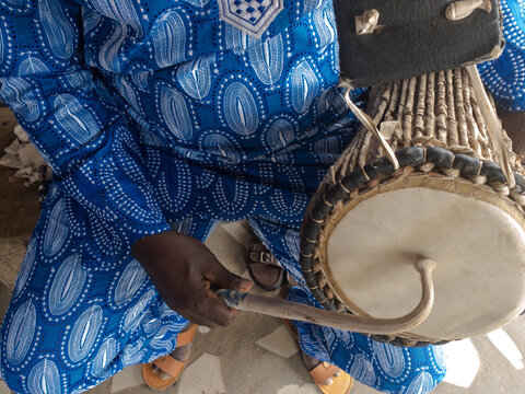 Man playing the talking drum