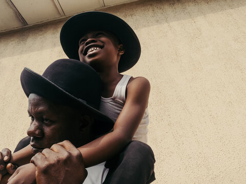 Amused son being carried by his father