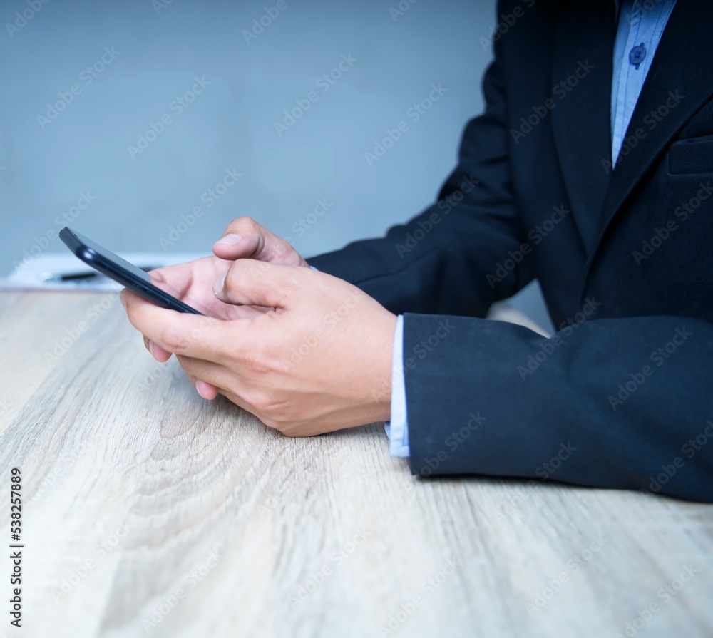 Poster close-up of a businessman in a suit using a smartphone to communicate with the client view marketing