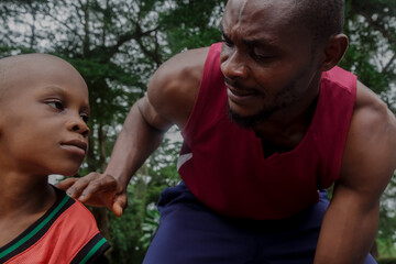 Boy and his father playing basketball