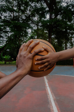 Father and son holding basketball