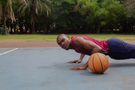 Man doing push ups before basketball training  - Powered by Adobe