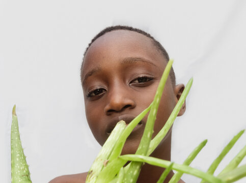 Child holding an aloe vera plant