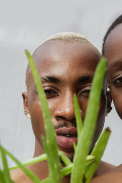 Portrait of blonde father behind an aloe vera