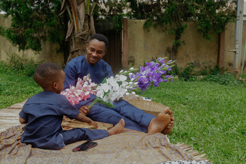 Nigerian father and little son at the park playing