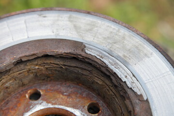 Heavy layered rust on ventilated car brake rotor disk surface close up