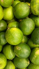Pile of fresh green sour lemons close up