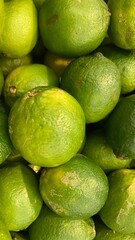 Pile of fresh green sour lemons close up