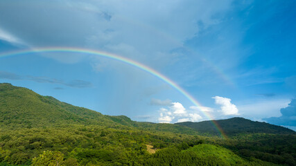 Rainbow on Sky in the mountains, Panorama of flying in a Nature rainbow in the rain, aerial view of Rainbow in mountain , Rainbow in the Mountains Puffy Clouds After the Rain