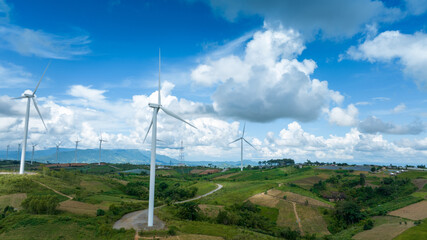 Fototapeta na wymiar Wind Turbines Windmill Energy Farm, Windmill on blue sky puffy clouds Alternative energy sources. Renewable electric sustainable nature energy technology. 