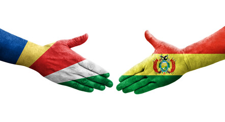 Handshake between Bolivia and Seychelles flags painted on hands, isolated transparent image.