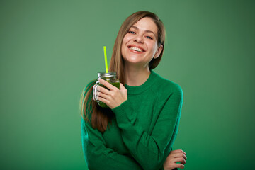 Smiling woman holding green smoothie jar. Isolated female advertising portrait on green.