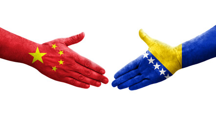 Handshake between Bosnia and China flags painted on hands, isolated transparent image.