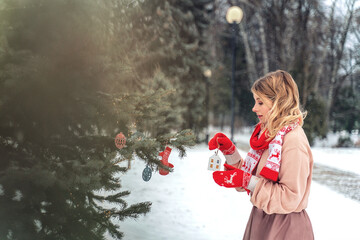 New Year's photos of a beautiful girl in the forest with a decorated Christmas tree, filled with comfort and magic