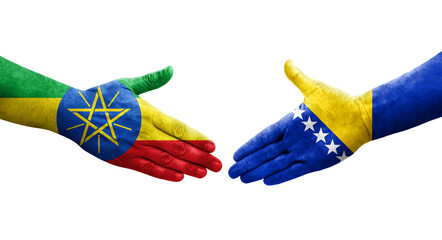 Handshake between Bosnia and Ethiopia flags painted on hands, isolated transparent image.