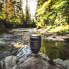 Cooking food using camping gas during the hike.