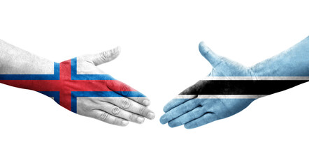 Handshake between Botswana and Faroe Islands flags painted on hands, isolated transparent image.