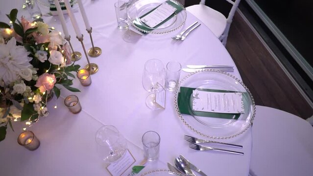 Laid wedding table with nameplates near cutlery