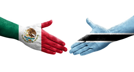 Handshake between Botswana and Mexico flags painted on hands, isolated transparent image.