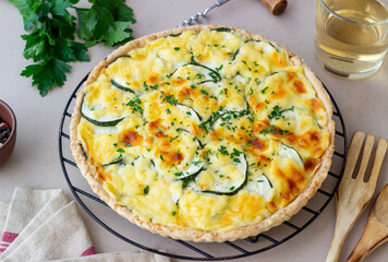 Pie with zucchini, cheese and herbs. Quiche. Vegetarian food. Healthy eating.